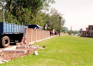 Pobořená cihlová zídka u fotbalového hřiště (lokalita 2 na obr.8). Foto autor.